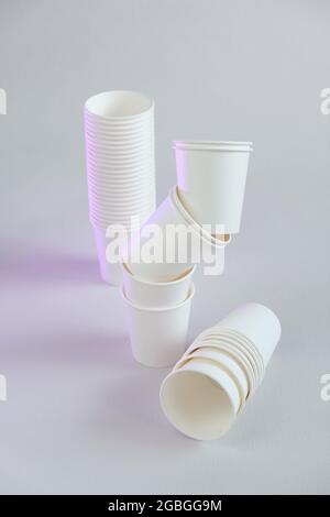 Geschirr ohne Plastik.Zero Waste, Kunststoff freies Konzept. Bio-Becher aus Bambus. Weiße Pappbecher Gruppe auf beigem Hintergrund.Papier Bambus Tassen Set Stockfoto