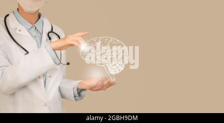 Ärztin hält virtuelles Gehirn in der Hand. Handgezeichnetes menschliches Organ, Kopierraum auf der rechten Seite, beige Farbe. Healthcare Krankenhaus Service Konzept Stock ph Stockfoto