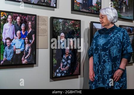 London, Großbritannien. August 2021. Joan Salter MBE, eine Holocaust-Überlebende, neben ihrem Portrait - Generations: Portraits of Holocaust Survivors eine neue Ausstellung im IWM London. Vom 6. August 2021 bis zum 7. Januar 2022 ist es eine neue Fotoausstellung im IWM London, die über 50 zeitgenössische Porträts von Holocaust-Überlebenden und ihren Familien zusammenbringt. Kredit: Guy Bell/Alamy Live Nachrichten Stockfoto