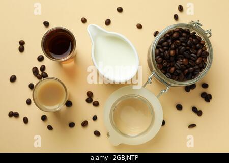 Konzept der Herstellung von irischem Kaffee auf beigem Hintergrund Stockfoto