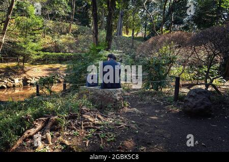 Tokio, Japan. März 2021. Ein Mann, der in einem lokalen Park in Tokio eine Mittagspause einnahm. (Bild: © Tanja Houwerzijl/SOPA Images via ZUMA Press Wire) Stockfoto