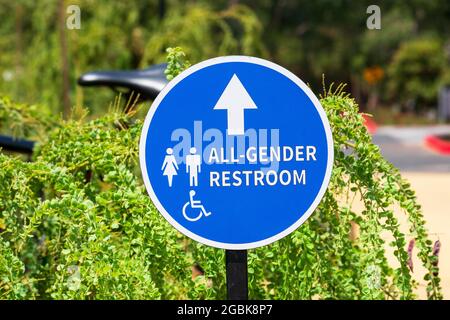 Außenschild mit Richtungspfeil für alle Badezimmer. ADA-konforme, geschlechtsneutrale Beschilderung für den Außenbereich. Stockfoto