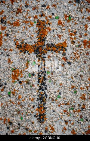 Christliches Kreuz auf alter Grabplatte. Stockfoto