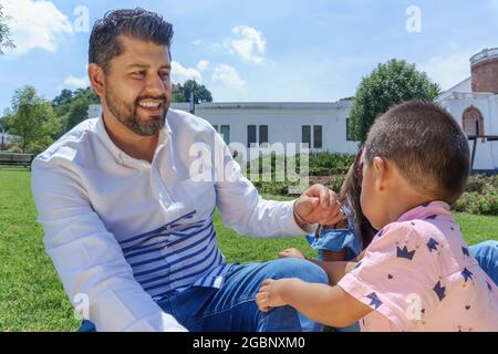 Wunderschöne Aussicht der hispanische Mann und die Frau hatten Spaß mit ihrem Kind im Park Stockfoto