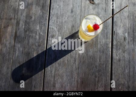 Eine Hand mit einem Whisky-Cocktail aus Orange, serviert in einer Außenbar in Bodega Bay, Kalifornien Stockfoto