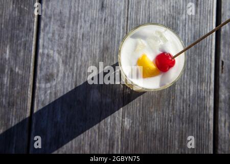 Eine Hand mit einem Whisky-Cocktail aus Orange, serviert in einer Außenbar in Bodega Bay, Kalifornien Stockfoto