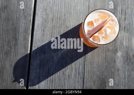 Ein Whisky-Cocktail aus Orange, serviert an einer Außenbar auf einem Holztisch in Bodega Bay, Kalifornien (über dem Kopf) Stockfoto