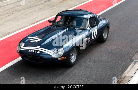Andreas Halusa fährt mit seinem halbleichten Jaguar E-Type 1964 auf der Boxengasse vor dem Start der International Trophy for Classic Pre-66 GT Cars Stockfoto