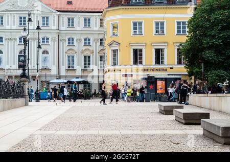 Warschau, Masovia, Polen - 3. Juli 2021: Menschen, die auf der Straße gegen Gebäude gehen. Stockfoto