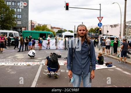 Berlin, Deutschland. August 2021. Lars Werner (r), Aktivist und Organisator der Gruppe Extinction Rebellion, bei der Straßenblockade an der Ecke Revaler Straße und Warschauer Straße in Berlin-Friedrichshain. Unter dem Motto "Jetzt ist es Schließzeit" fordern die Aktivisten eine "sofortige Notfallreaktion" auf die Klimakatastrophe. Quelle: Gerald Matzka/dpa/Alamy Live News Stockfoto