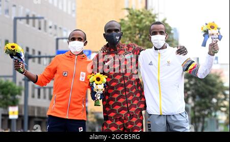 Sapporo, Japan. August 2021. Goldmedaillengewinnerin Eliud Kipchoge (C) aus Kenia, Silbermedaillengewinnerin Abdi Nageeye (L) aus den Niederlanden und Bronzemedaillengewinnerin Bashir Abdi aus Belgien werden während der Blumenzeremonie für den Männer-Marathon bei den Olympischen Spielen 2020 in Tokio in Sapporo, Japan, am 8. August 2021, gesehen. Kredit: Guo Chen/Xinhua/Alamy Live Nachrichten Stockfoto