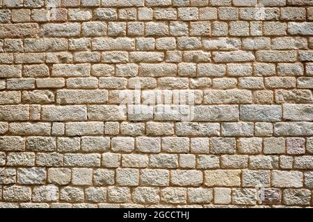 Hintergrund von einer normalen natürlichen alten Steinmauer Stockfoto