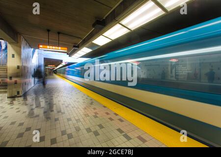 Eine U-Bahn fährt vorbei, während die Leute warten. Die Metro von Montreal (Métro de Montréal) ist eine gummimüde U-Bahn, Montreal, Quebec Stockfoto