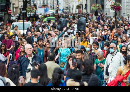 London, Großbritannien. August 2021. Hare Krishna-Anhänger nehmen am Rathayatra-Festival oder dem Chariots-Festival Teil. In diesem Jahr wurde nur ein geschmückter Wagen (normalerweise drei) vom Hyde Park zum Trafalgar Square gerollt. Einmal auf dem Platz, genießen eifrige Anhänger kostenloses vegetarisches Essen und Erfrischungen während des Festivals. Kredit: Stephen Chung/Alamy Live Nachrichten Stockfoto