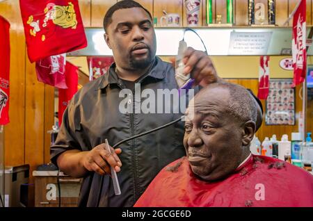 Ein Friseur schneidet Haare bei Gibson's Hair Styles and Cuts, 23. April 2013, in West Point, Mississippi. Die Einheimischen sagen, dass in der Kleinstadt Arbeitsplätze benötigt werden, aber sie Stockfoto