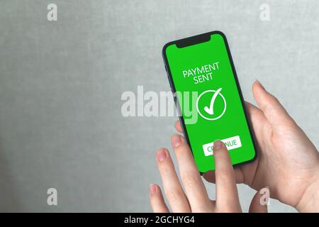 Frau, die das Geld per Mobiltelefon sendet, Hintergrund des Online-Banking-Konzepts, Technologie für den Online-Transfer Stockfoto