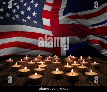 Trauerkerzen brennen auf den Flaggen der USA und Großbritanniens im Hintergrund. Memorial Weekend, Tag der Patrioten, Nationalfeiertag. Bu Stockfoto