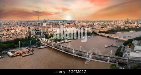 Luftaufnahme der Stadt London über der berühmten Themse und berühmten Landmarks am Flussufer in der Abenddämmerung, in England - Großbritannien Stockfoto