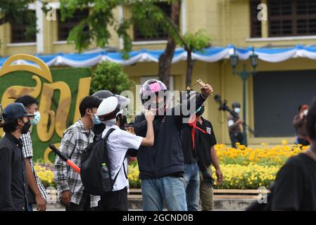 Bangkok, Thailand. August 2021. Ein regierungsfeindlicher Protestler wirft Steine auf die thailändische Bereitschaftspolizei, während sie am 7. August 2021 auf die Ratchadamnoen Road im Zentrum von Bangkok angreift. (Foto von Teera Noisakran/Pacific Press/Sipa USA) Quelle: SIPA USA/Alamy Live News Stockfoto