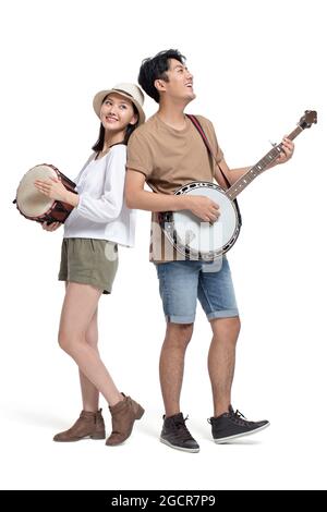 Junges Paar spielt Musikinstrument Stockfoto