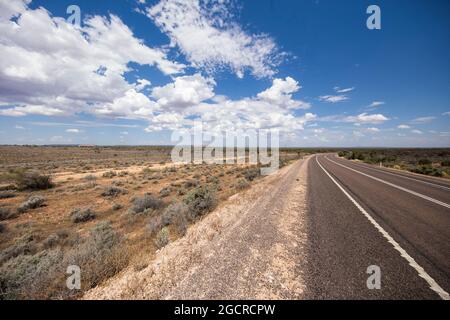 Der Weg ins nichts im australischen Outback. Der stuart Highway auf dem Weg zum Uluru oder Ayers Rock. Leere Straße durch die weite offene Wohnung austr Stockfoto