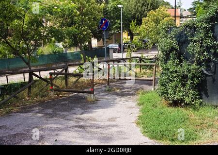 Holzbarrieren mit einem Straßenschild, das das Ende des Fußgängerweges anzeigt (Marken, Italien, Europa) Stockfoto