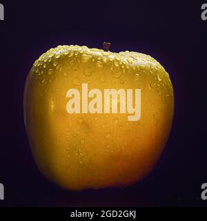 apfel mit Wassertropfen auf schwarzem Hintergrund Stockfoto