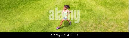 Läuferin Frau läuft auf Gras Hintergrund Outdoor-Training für Marathon. Draufsicht auf das Mädchen der asiatischen Sportlerin beim hiit-Lauf. Banner. Stockfoto
