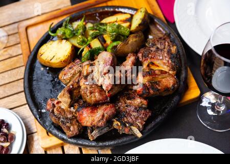 Gegrilltes Rinderhackfleisch in Scheiben mit gebackenen Kartoffeln und Paprika Stockfoto