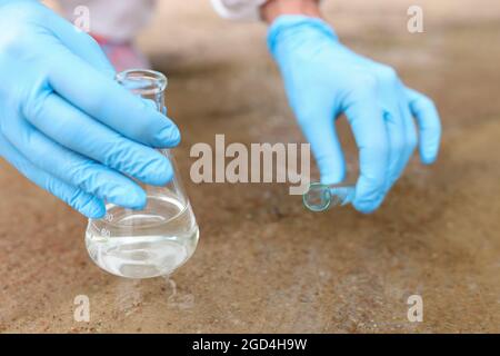 Wasserproben aus dem Fluss zur Analyse in der Nahaufnahme des Kolben Stockfoto
