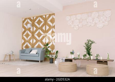 Stilvolle Einrichtung mit Designer-Holzwand und blauem Sofa, Couchtisch, Ottomanen, Dekor und eleganten persönlichen Accessoires in einem modernen Wohndekor. Stockfoto