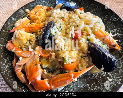 Italienisches Risotto mit Garnelen, Muscheln, Oktopus, Muscheln und Tomaten Stockfoto