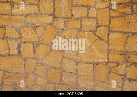 Sandsteinmauer, Hintergrund, Nahaufnahme. Umweltfreundliche Konstruktion Stockfoto