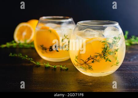 Meyer Lemon and Thyme Bees Knees Cocktails: Gin-Cocktails mit Meyer-Zitronensaft und garniert mit Thymianzweige und einer Scheibe Zitrone Stockfoto
