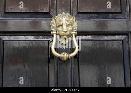 Türklopfer an einer schwarzen Holztür London Street England Stockfoto