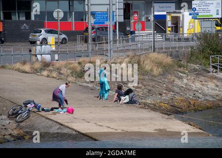 Fishguard, Pembrokeshire, großbritannien . 12. August 2021 Touristen strömen in koatale Städte, jetzt werden in wales Estrictionss lebend, die Temperaturen steigen auf 18 Grad Aktivitäten am Meer und Café-Kultur wieder Kredit: Debra Angel/Alamy Live News Stockfoto