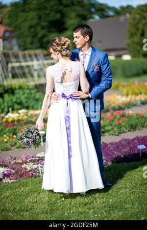 Glückliche junge Braut und Bräutigam an ihrem Hochzeitstag. Hochzeitspaar - neue Familie! Hochzeitskleid. Brauthochzeit Blumenstrauß Stockfoto