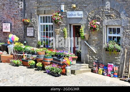 Sommertime Topf gewachsen Sommer Blumen & Gartenartikel außerhalb Steinwand Eisenwaren Einzelhandel Geschäft Grassington Wharfedale Yorkshire England Stockfoto