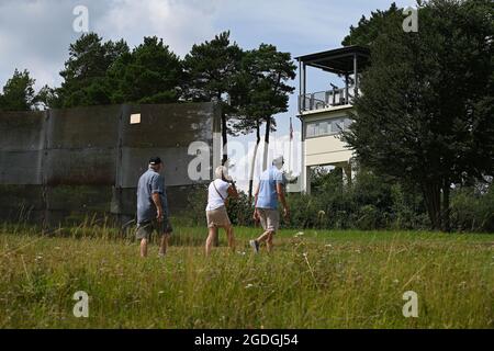 Geisa, Deutschland. August 2021. Blick auf einen ehemaligen Aussichtsturm hinter einem Grenzzaun an der Point Alpha Gedenkstätte. Zum Gedenken an den Bau der Berliner Mauer vor 60 Jahren und die innerdeutsche Teilung wurde eine Gedenkveranstaltung abgehalten. Quelle: Swen Pförtner/dpa-Zentralbild/dpa/Alamy Live News Stockfoto