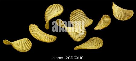 Geriffelte Kartoffelchips isoliert auf schwarzem Hintergrund Stockfoto