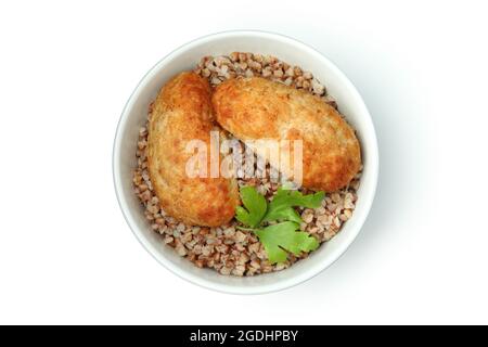 Schüssel mit Schnitzel, Buchweizen und Petersilie isoliert auf weißem Hintergrund Stockfoto