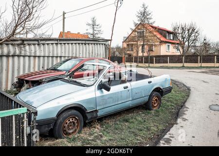 Zwei alte, zerstörte Autos mit rostigen Reifen, einer ohne Dach Stockfoto