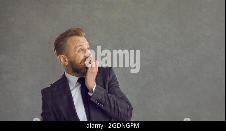Lustig verängstigt Geschäftsmann beißen Nägel und Blick auf die Seite auf Copy Space Hintergrund Stockfoto