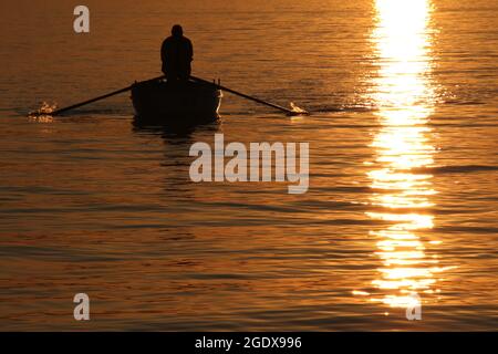 Fischer paddeln bei Sonnenuntergang Stockfoto