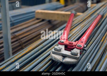 Große Zangen oder Haarschneider zum Schneiden von Draht- oder Stahlstangen. Manuelle manuelle Drahtseilschere aus Stahl. Bauwerkzeug auf einer Baustelle Stockfoto