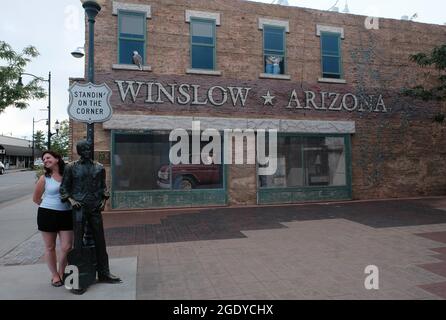 Winslow, Arizona, USA. August 2021. Standin' on the Corner Park in Winslow, Arizona. Eine Statue des Eagles-Mitglieds Glen Frey erinnert an den Hit Take IT Easy aus den 1960er Jahren mit der Zeile „nun, ich stehe an der Ecke in Winslow, Arizona, und es gibt einen so schönen Anblick zu sehen. Es ist ein Mädchen, mein Herr, in einer flachen Furt, die langsam einen Schau mich an. nimmt. Der Park enthält ein zweistöckiges Trompe-l'Ceil-Wandgemälde von John Hugh sowie eine Statue eines Mannes, der eine Gitarre vom Bildhauer Ron Adamson hält. Winslow ist ein beliebtes Touristenziel auf der berühmten alten Route 66, die sich im Navajo Reservat befindet. (C Stockfoto