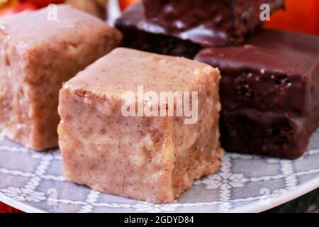 Gingerbread cubes in chocolate, sweet dessert, homemade cake. Stock Photo