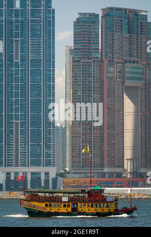 Das „Wing on Travel“ (ehemals „Noble House“), ein Holzboot im chinesischen Stil, bringt Touristen auf eine Vergnügungskreuzfahrt im Victoria Harbour, Hongkong Stockfoto