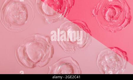 Transparente Farbmuster-Gel-Textur auf rosa Hintergrund. Hautpflege kosmetische Produkt Textur von Kollagen oder Hyaluron Flüssigserum. Kreismuster erstellt Stockfoto