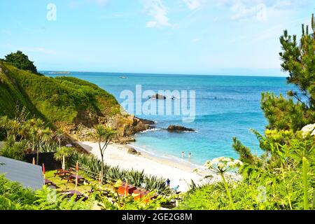 Herm, Kanalinseln, Großbritannien - 1. Juli 2016: Das Café und der wunderschöne Strand an der Belvoir Bay an einem ruhigen Sommernachmittag, nur wenige Menschen in der Nähe. Stockfoto